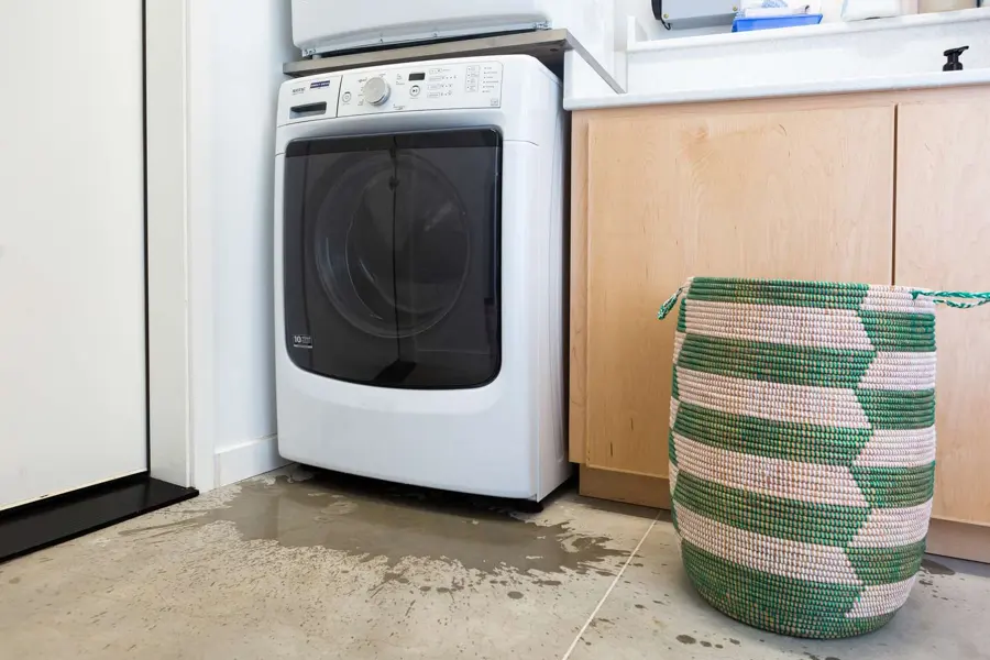 A leaking washer supply line flooding a Maple Grove, MN laundry room